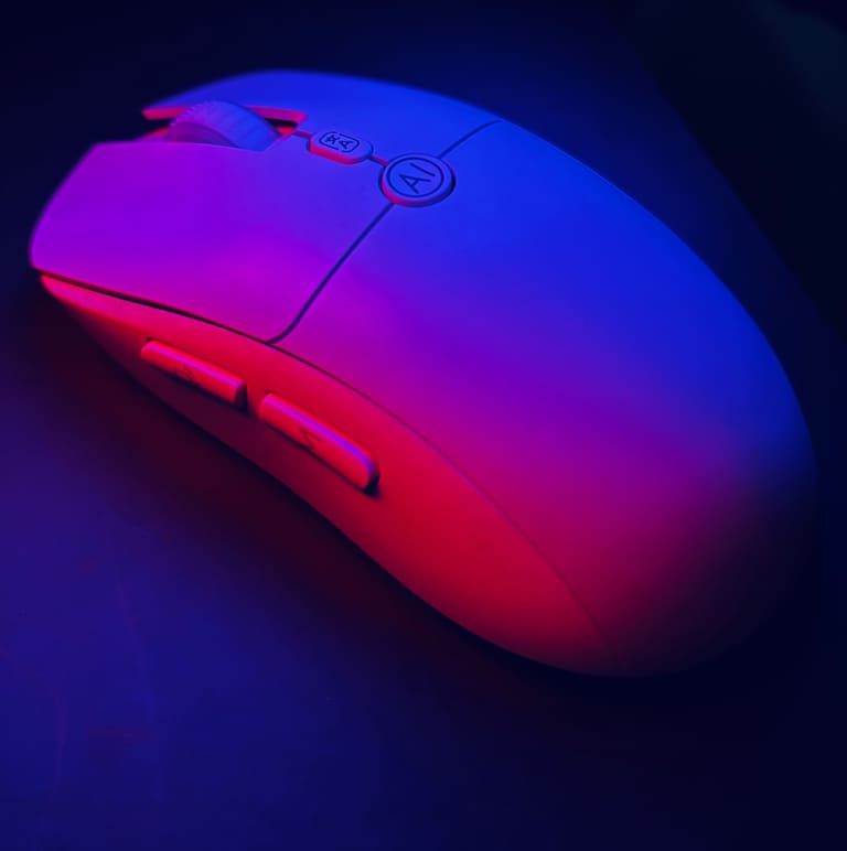 Aitroneecs AI Smart Voice Mouse in white, lit in blue and red, showing the AI button, 文A button and side buttons